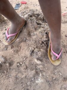 Pieds nus d’une petite fille africaine debout sur la terre