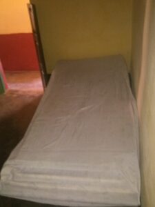 Photographie d'un lit d'hôpital africain, vide ou avec un patient